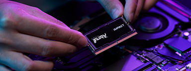 一只手正在将一个 SODIMM 模组安装到笔记本电脑的空闲插槽中。